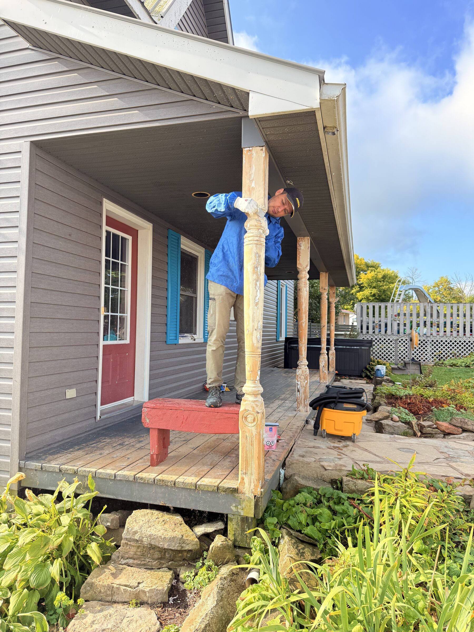 Before: Bare wood turned porch posts being prepped on a Spencerville home