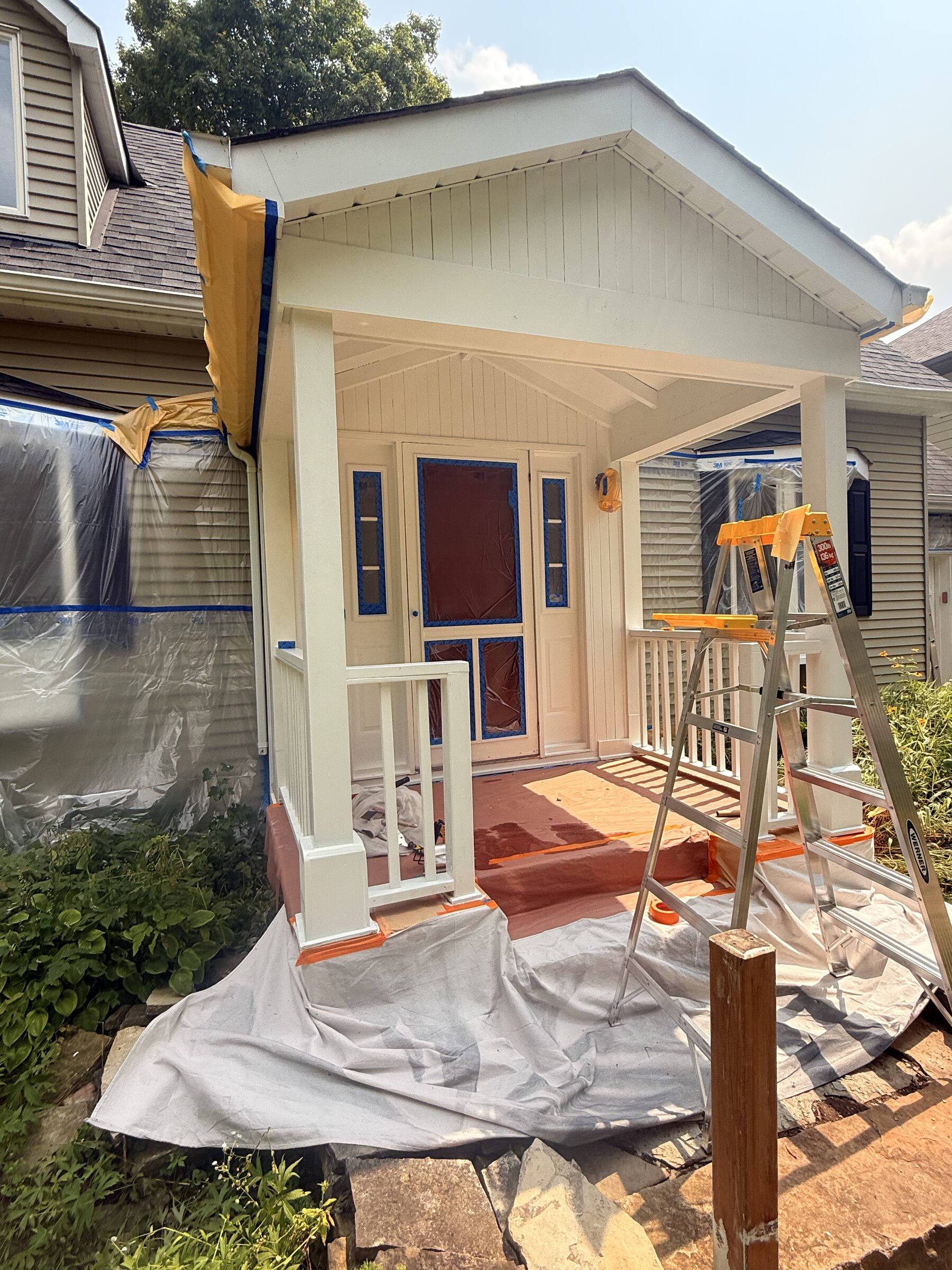 Front porch entry masked off with tape and plastic before painting